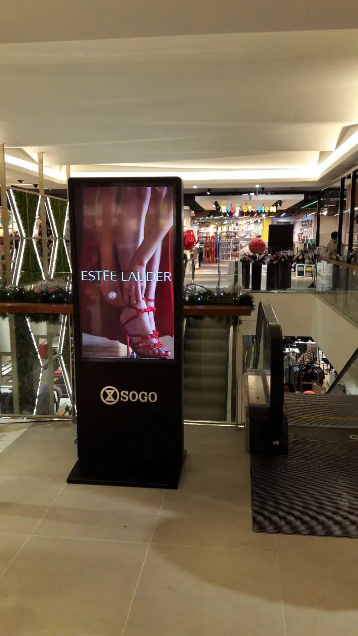 Standing signage next to an escalator