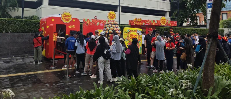 Crowd queueing at the Chupa Chups photobooth and activation booths by the road