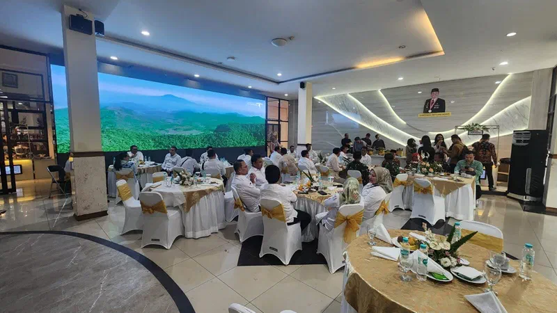 The lobby videotron during an event, with guests seated at tables